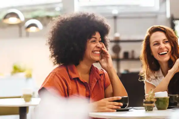 Friends Chatting At Table 1920X650